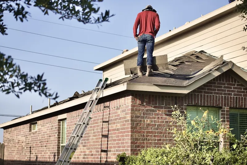 Professional roofer working on a residential roof in Riverwalk